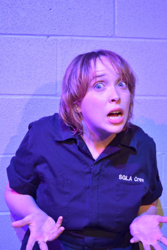 person looking at camera with palms turned up and scared expression on their face