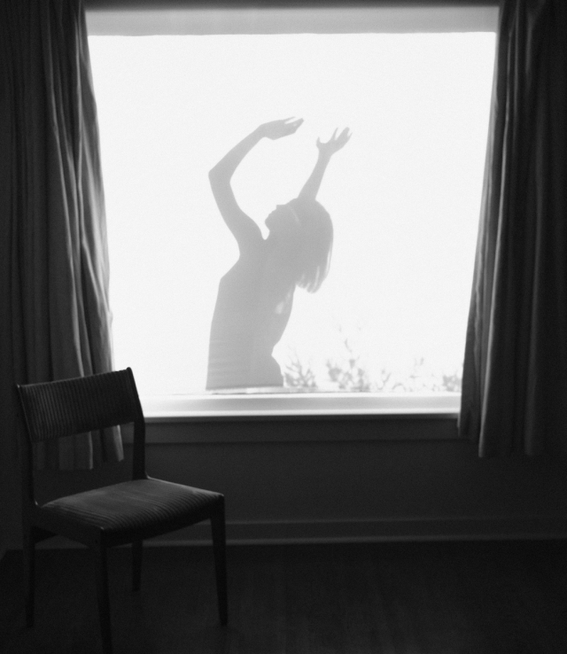 black and white photo of a dancer's silhouette in the window