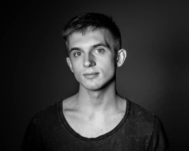 a black & white photo of nat against a dark flat background