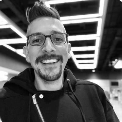 man smiling with short hair and goatee
