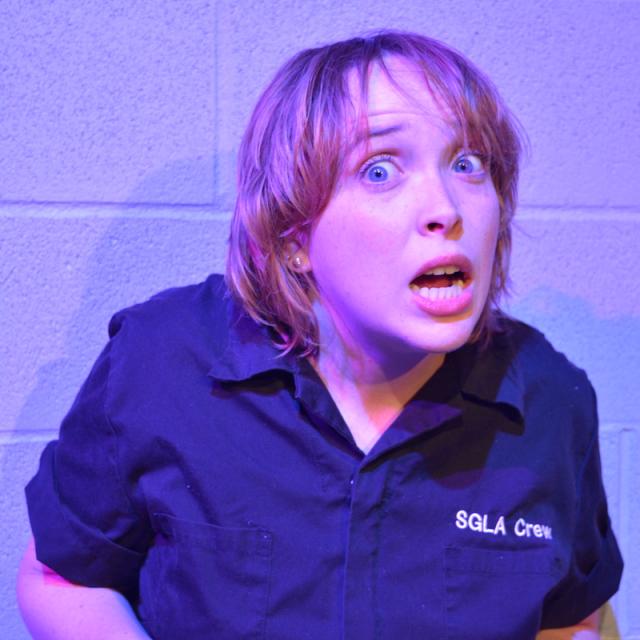 person looking at camera with palms turned up and scared expression on their face