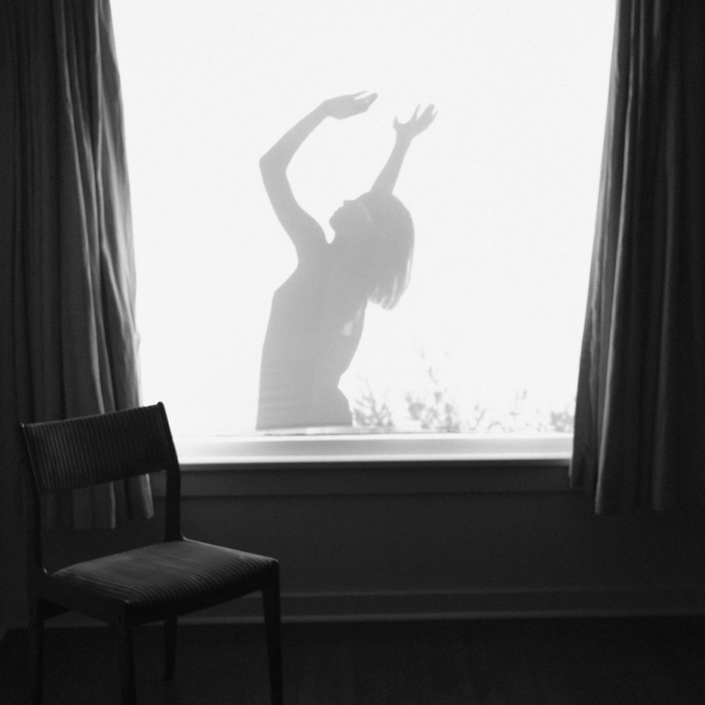 black and white photo of a dancer's silhouette in the window