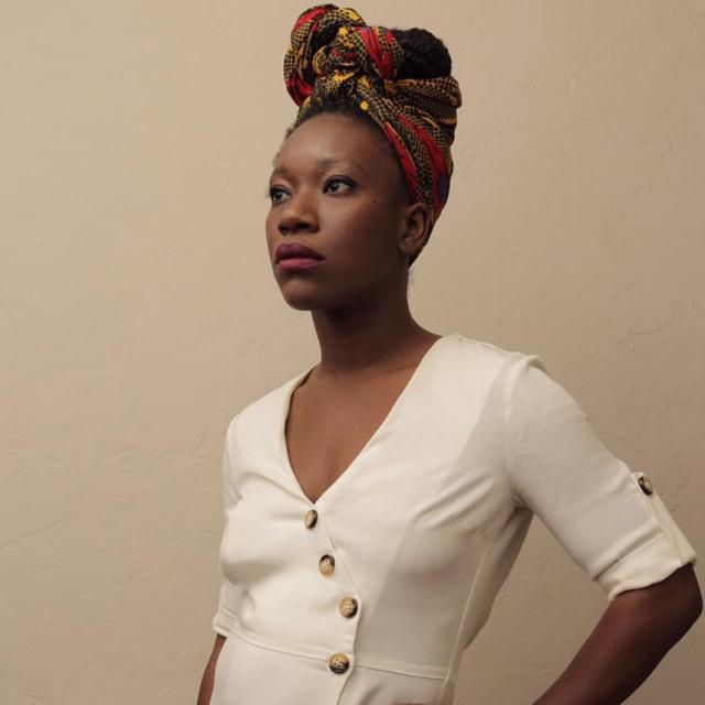 woman in white dress with hair wrapped up