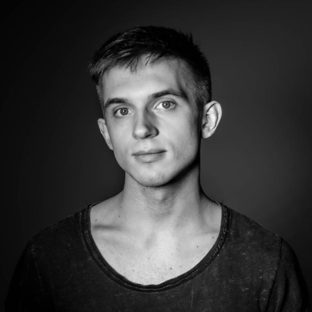 a black & white photo of nat against a dark flat background