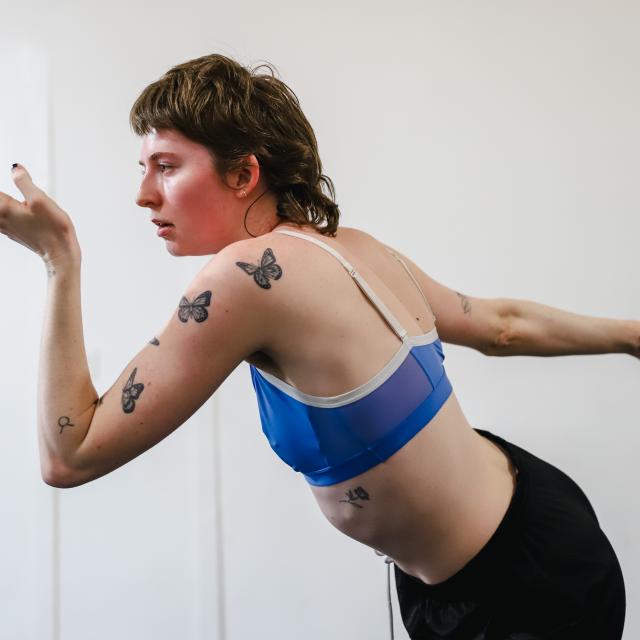 an image of mason amidst movement starting between her hands and outward in front of her