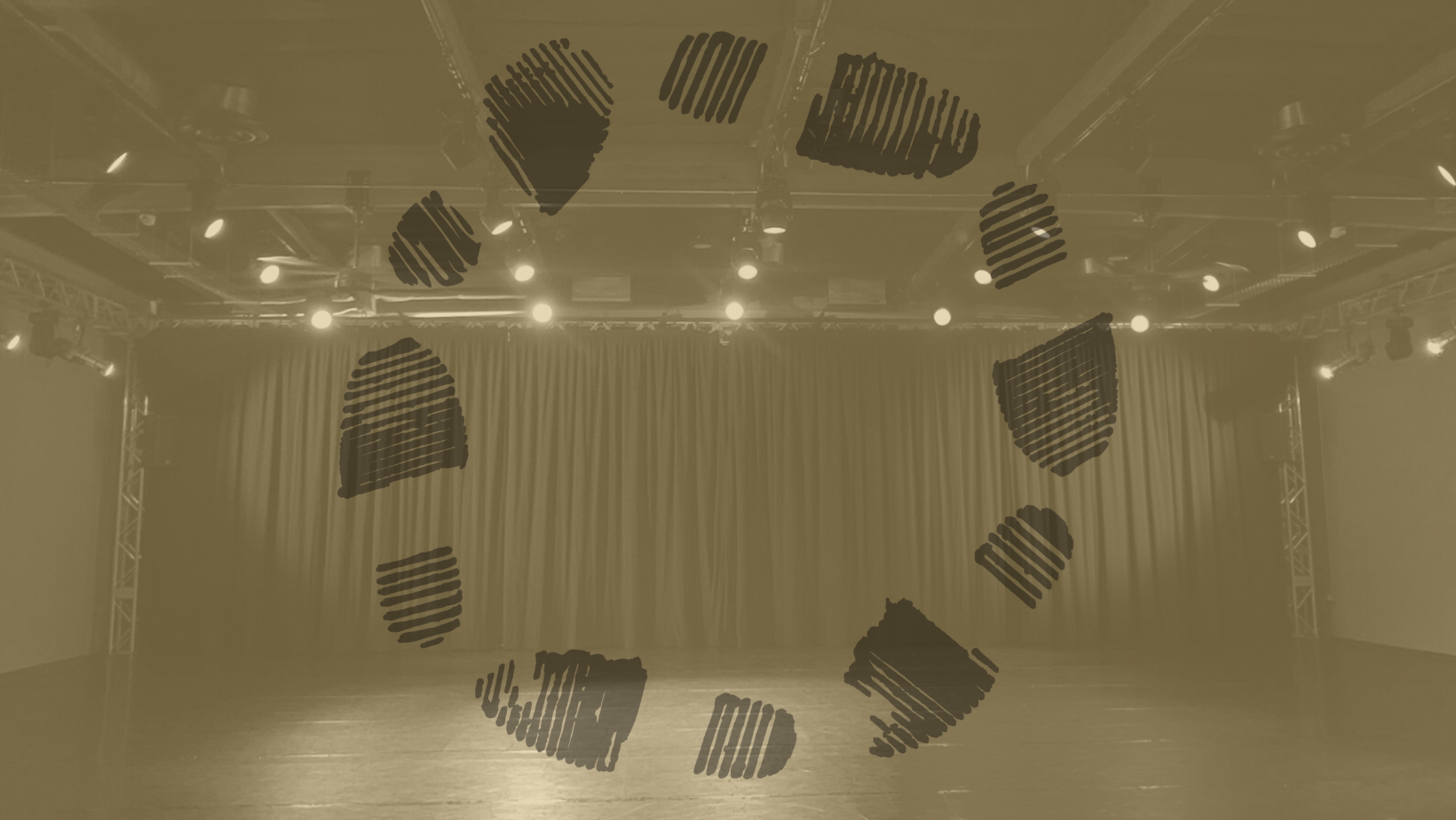 large space with theatrical lights and a black curtain overlaid with logo of footprints in a circle